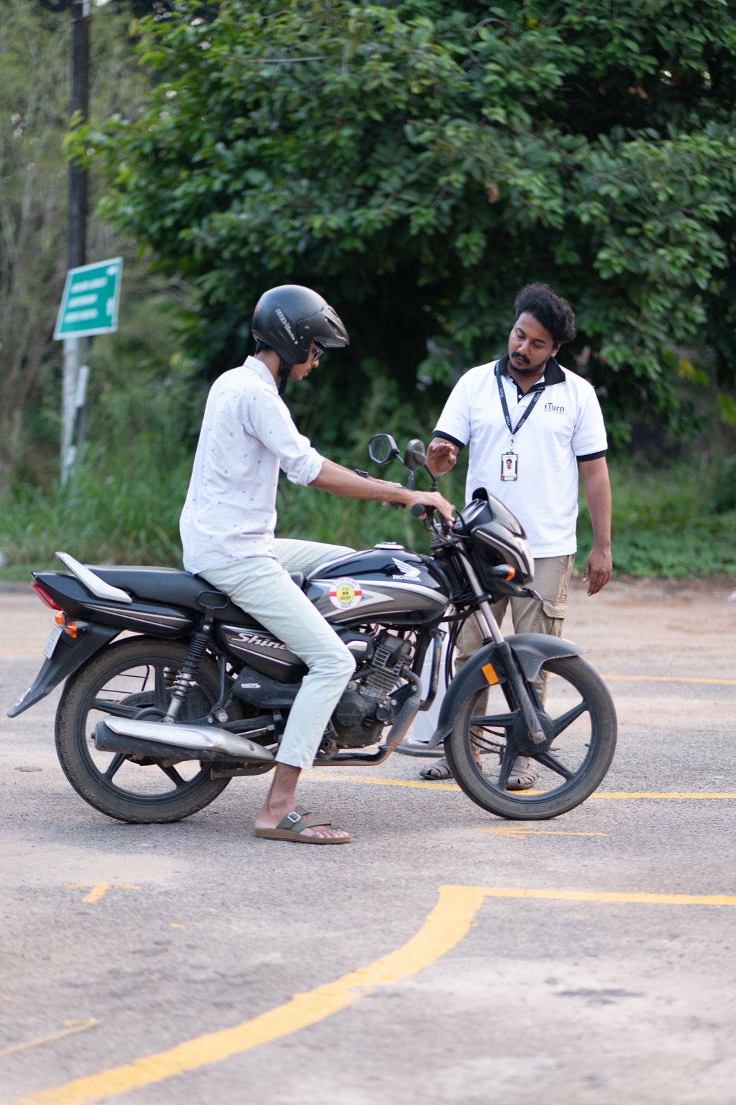 Instructor coaching a learner on a motorcycle
